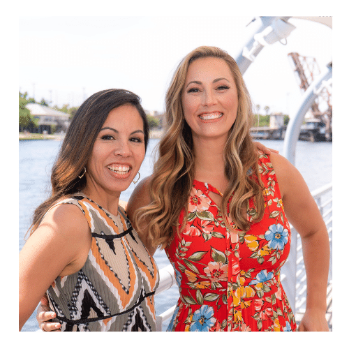 Two smiling women who own Loving Life Today: Therapy & Counseling standing outside Tampa Riverwalk.